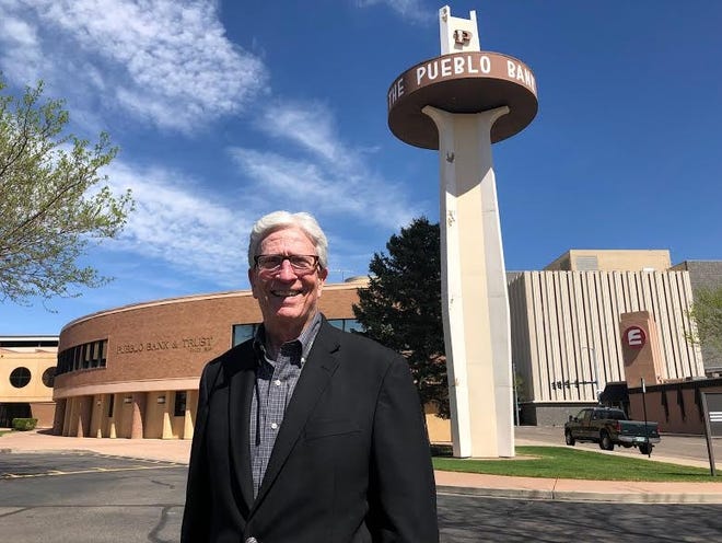 Mickey Moore, who is retiring as president of PB&T, the former Pueblo Bank & Trust, poses Thursday near the bank's signature revolving sign at its main branch at 301 W. Fifth St. [CHIEFTAIN PHOTO/ANTHONY A. MESTAS]
