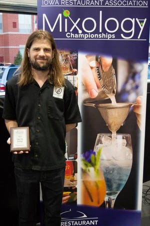 Ryan Jeffrey holds his winning plaque after the Top Mixologist competition on Thursday. Photo courtesy of Iowa Restaurant Association