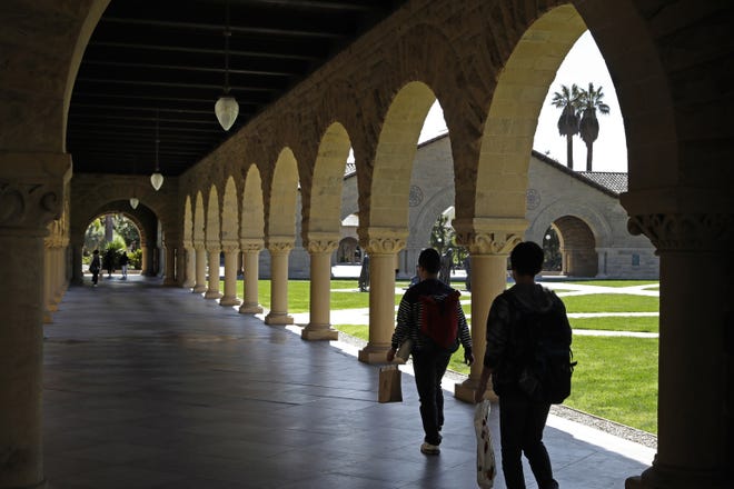 People walk on the Stanford University campus in Santa Clara, Calif. Whether you're asking your parents for financial help, or they're offering it, think twice before accepting. If Mom and Dad aren't on track for retirement, it could end up costing everyone. [AP File Photo/Ben Margot]
