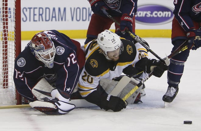 Columbus Blue Jackets goalie Sergei Bobrovsky (left) makes a save as Boston Bruins' Joakim Nordstrom collides with him during the first period of Game 3 of a second-round playoff series on Tuesday in Columbus, Ohio. [AP Photo/Jay LaPrete]