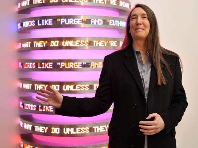 U.S. artist Jenny Holzer poses in front of a piece entitled "Monument" at the Fondation Beyeler in Riehen, Switzerland, Oct. 30, 2009. [File/AP]