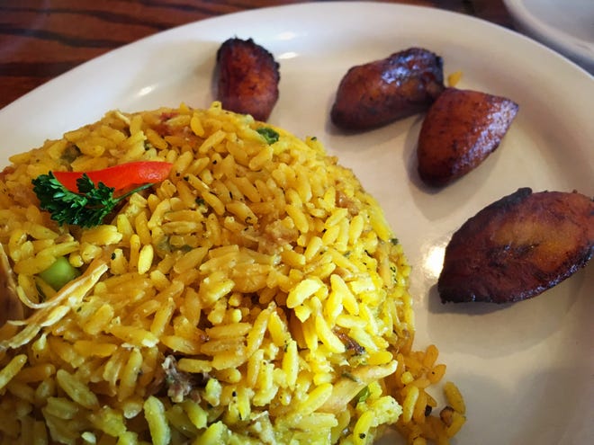 Chicken and rice at West Caribbean Cuban Restaurant. [ERIC PERA/THE LEDGER]