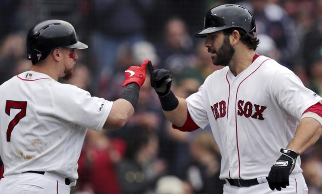 Red Sox first baseman Mitch Moreland (right) gets a high-pinky from Christian Vazquez after his solo home run during the fourth inning of Boston's 7-3 win over the Athletics. Vazquez would hit a solo home run of his own in the eighth inning. [AP Photo/Charles Krupa]