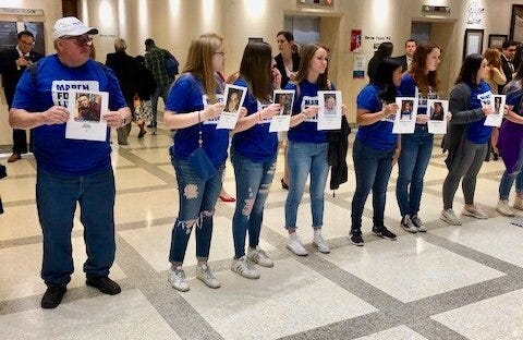 TALLAHASSEE -- Protesters who oppose legislation arming teachers line the Rotunda leading into the Florida House chamber on April 24., many carrying photos of those killed at Marjory Stoneman Douglas High School in Parkland or the Pulse nightclub in Orlando. [Photos by John Kennedy/GateHouse Capitol Bureua]