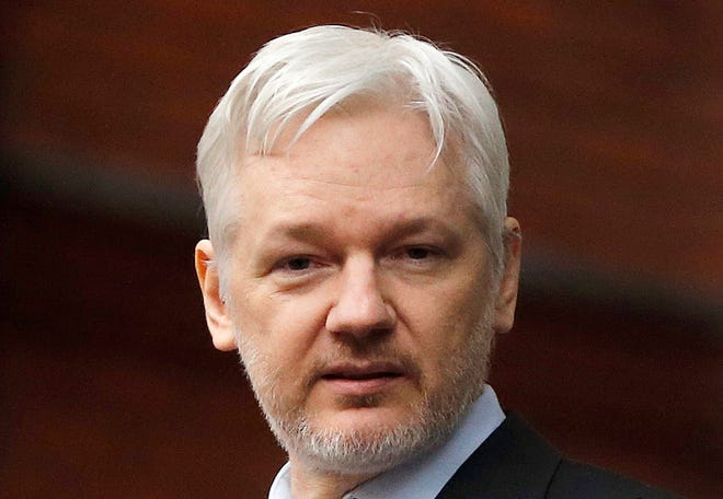 FILE - In this Feb. 5, 2016, file photo, WikiLeaks founder Julian Assange stands on the balcony of the Ecuadorean Embassy in London. London police say they've arrested WikiLeaks founder Julian Assange at the Ecuadorian embassy, it was reported on Thursday, April 11, 2019. (AP Photo/Frank Augstein, File)