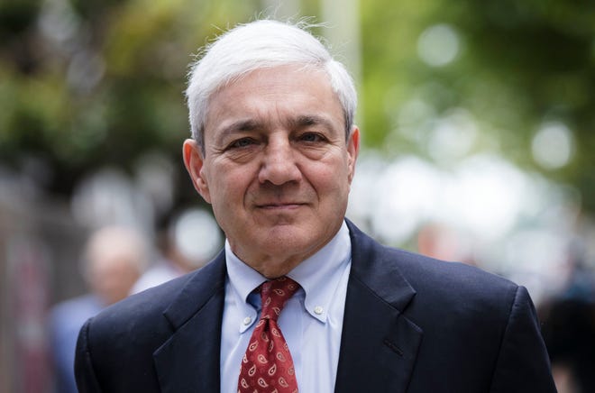 FILE - In this June 2, 2017, file photo, former Penn State President Graham Spanier departs after his sentencing hearing at the Dauphin County Courthouse in Harrisburg, Pa. A federal judge on Tuesday, April 30, 2019 has thrown out Spanier's child-endangerment conviction, less than a day before he was due to turn himself in to jail. (AP Photo/Matt Rourke, File)