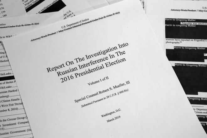 Special Counsel Robert Mueller's redacted report on Russian interference in the 2016 presidential election is photographed in Washington. [AP Photo/Jon Elswick]