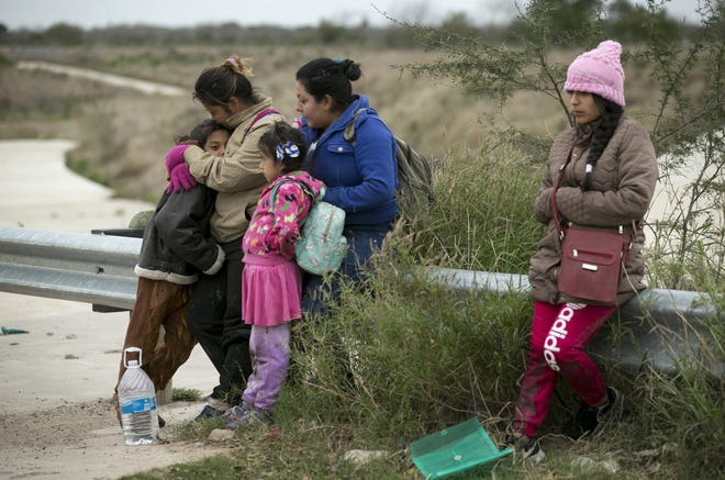 Maria Candelaria of El Salvador embraces her 8-year-old daughter Kimberly Alejandra Rodriguez Cruz in February, moments after they crossed the Rio Grande to Roma and immediately surrendered themselves to the Border Patrol. Traveling with them were Madalene Idalia of Guatemala with her 7-year-old daughter Jouli Marian and 17-year-old Diana Lorena of Ecuador. [JAY JANNER/AMERICAN-STATESMAN]