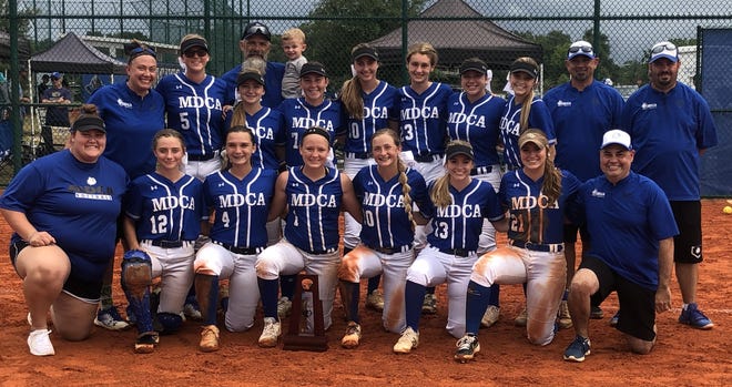 Mount Dora Christian Academy players and coaches pose with the trophy after winning the school's fourth consecutive softball district title on Thursday. [Submitted]