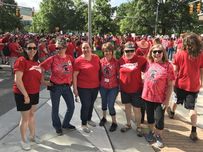Between 15 and 20 teachers from all three of the county's school systems were seen at Wednesday's Day of Action rally in Raleigh. Three Lexington teachers and three Davidson County teachers stoped to pose for a picture during the march. [Contributed photo]