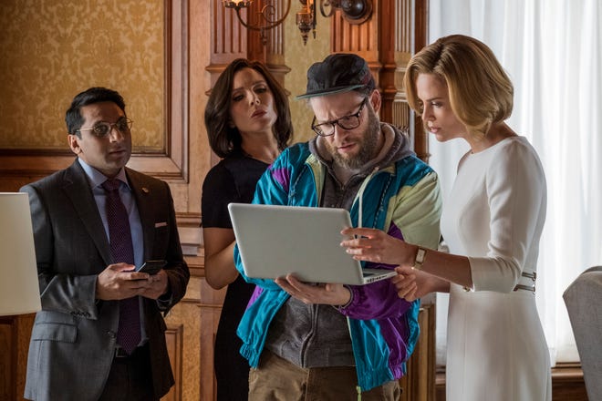This image released by Lionsgate shows Ravi Patel, from left, June Diane Raphael, Seth Rogen and Charlize Theron in a scene from "Long Shot." (Philippe Bossé/Lionsgate via AP)