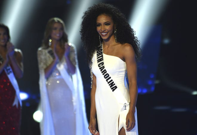 Miss North Carolina Cheslie Kryst who won the 2019 Miss USA final competition stands onstage in the Grand Theatre in the Grand Sierra Resort in Reno on May 2, 2019. Kryst, a 27-year-old lawyer from North Carolina who represents prison inmates for free, won the 2019 Miss USA title Thursday night in a diverse field that included teachers, nurses and members of the military. (Jason Bean/The Reno Gazette-Journal via AP)