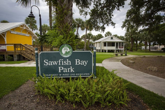 The historical Aicher House (right) at the southern end of Sawfish Bay Park at 1133 Alt A1A in Jupiter, Thursday, May 2, 2019. The town's historical resources board just recommended against a town plan to put an ecotourism vendor in the house or nearby. [ALLEN EYESTONE/palmbeachpost.com]