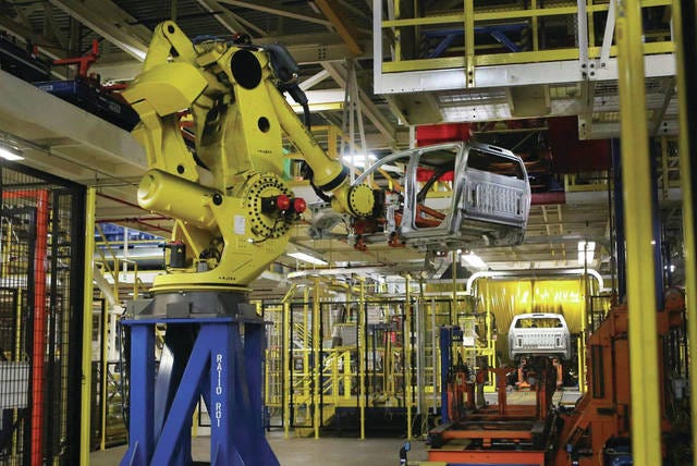 A robot that workers nicknamed “Godzilla” picks up truck cabs from the first floor assembly line and puts them on the second floor assembly line. Then they continue their journey through the body shop at the GM truck and van assembly plant in Wentzville. (J.B. Forbes / St. Louis Post Dispatch)