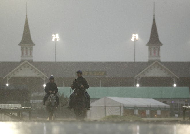 Horses come off the track after an early-morning workout Friday at Churchill Downs in Louisville, Kentucky.       

[Charlie Riedel / Associated Press]