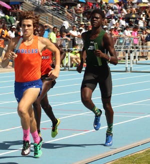 Alex Hastings of Bolles (left) leads the pack during the Class 2A boys 4x800-meter relay at the FHSAA track championships Saturday. [Clayton Freeman/Florida Times-Union]