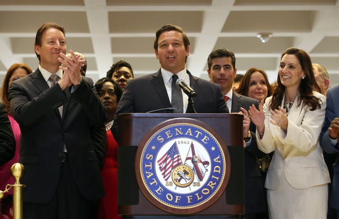 Gov. Ron DeSantis, center, is applauded by Senate president Bill Galvano, R-Bradenton, left, House speaker Jose Oliva R-Miami Lakes, center right, and Lt. Gov. Jeanette Nunez, far right, at the end of session Saturday in Tallahassee. [Steve Cannon/The Associated Press]