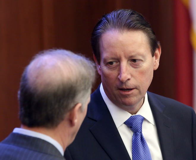 Senate President Bill Galvano, R-Bradenton, right, confers with Sen. Wilton Simpson, R-Trilby, during session Wednesday in Tallahassee. [AP Photo / Steve Cannon]