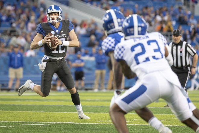 Quarterback Gunnar Hoak of Dublin Coffman scrambles during Kentucky's spring game on April 12. Hoak played in five games for the Wildcats last season, completing 13 of 26 passes for 167 yards with two TDs and one interception. [Bryan Woolston/The Associated Press]