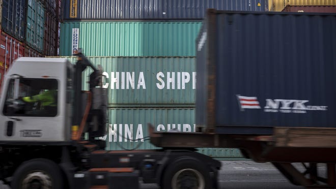 A jockey truck passes a stack of 40-foot China Shipping containers at the Port of Savannah in Savannah, Ga. President Donald Trump turned up the pressure on China Sunday, threatening to hike tariffs on $200 billion worth of Chinese goods. [Stephen B. Morton/AP Photo]