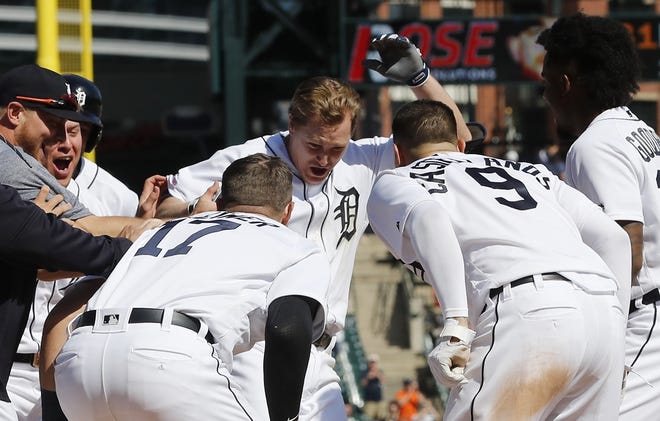 Detroit Tigers' Brandon Dixon is greeted at home plate after his three-run home run during the 10th inning of a baseball game against the Kansas City Royals, Sunday, May 5, 2019, in Detroit. (AP Photo/Carlos Osorio)