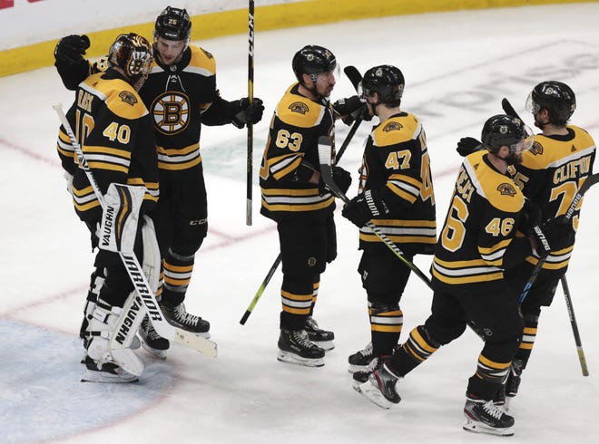 Boston Bruins goaltender Tuukka Rask (left) is congratulated after a win against the Columbus Blue Jackets in Game 5 of the second-round playoff series on Saturday. [AP Photo/Charles Krupa]