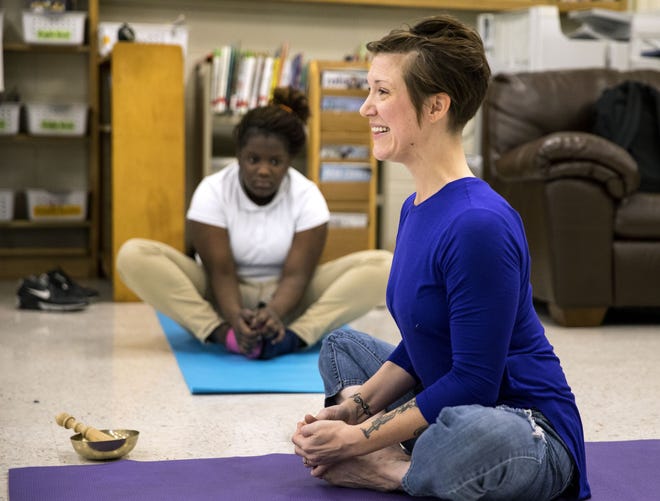 Ashley Krstulovich leads the after-school meeting of the Yoga and Mindfulness Club at Washington Middle School in 2017. [File/The State Journal-Register]