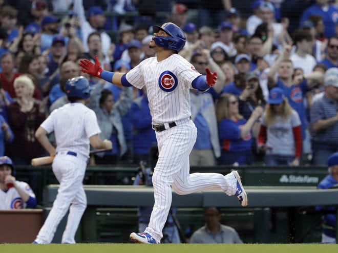 The Chicago Cubs' Willson Contreras celebrates as he rounds the bases after hitting a solo home run during the second inning against the St. Louis Cardinals, Sunday in Chicago. [NAM Y. HUH/THE ASSOCIATED PRESS]