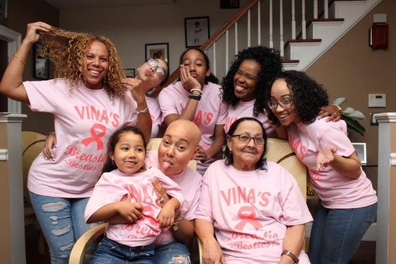Members of Team "vina's Breastie Besties" pose at the home of Vina Tavares, center, on April 26. [CORLYN VOORHEES/THE ENTERPRISE]