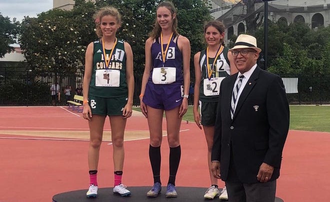 Ascension Catholic's Haley Dupre (middle) celebrates winning the state title in the 1,600, alongside Highland Baptist's Maegan Champagne (right) and Cedar Creek's Ansley Long (left). Photo courtesy of LHSAA.
