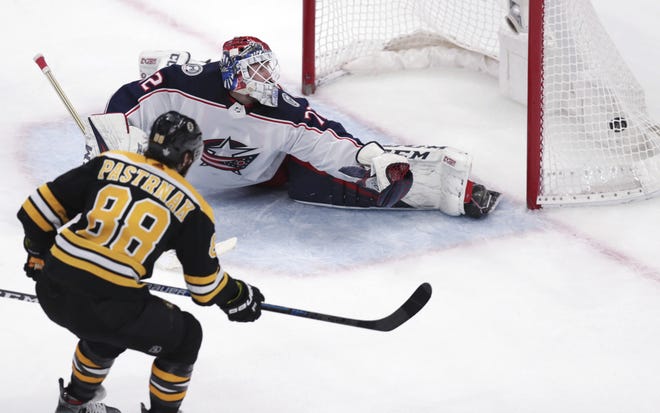 Boston Bruins right winger David Pastrnak (left) beats Columbus Blue Jackets goaltender Sergei Bobrovsky for his second goal of Game 5 in the B's 4-3 win on Saturday in Boston. [AP File Photo/Charles Krupa]