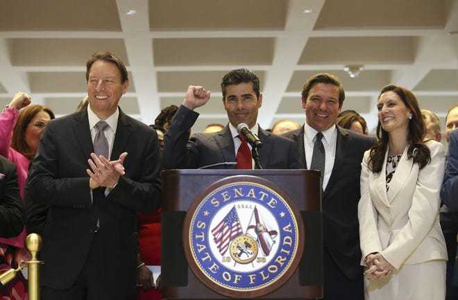 House speaker Jose Oliva R-Miami Lakes, center, gives a fist pump at the end of his remarks as Senate president Bill Galvano, R- Bradenton, left, Gov. Ron Desantis, center right, and Lt Gov. Jeanette Nunez, far right, react at the end of session on Saturday in Tallahassee. [Steve Cannon/AP]