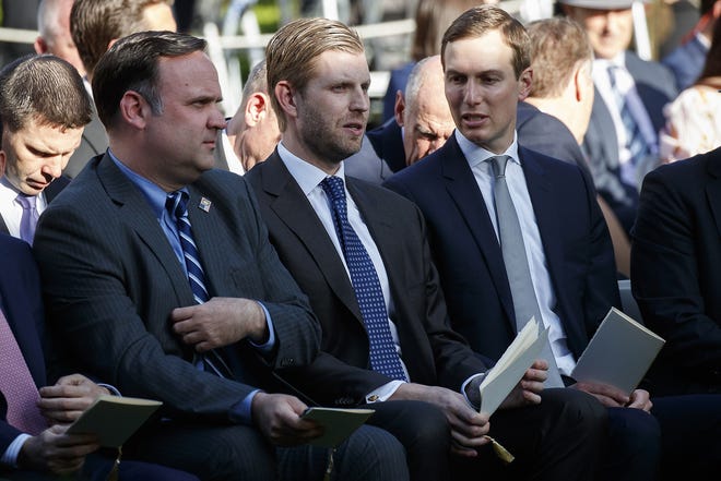 White House Social Media Director Dan Scavino, left, Eric Trump, center, and White House senior adviser Jared Kushner wait for the arrival of President Donald Trump to present golfer Tiger Woods with the Presidential Medal of Freedom, in the Rose Garden of the White House, Monday in Washington. President Donald Trump has signed off on a new immigration plan being spearheaded by Kushner that appeared to receive a positive reception from Republican senators briefed on it Tuesday. [EVAN VUCCI/ASSOCIATED PRESS]