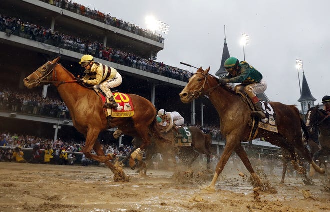 Flavien Prat rides Country House to the finish line during the Kentucky Derby on Saturday at Churchill Downs. [AP Photo/Matt Slocum]