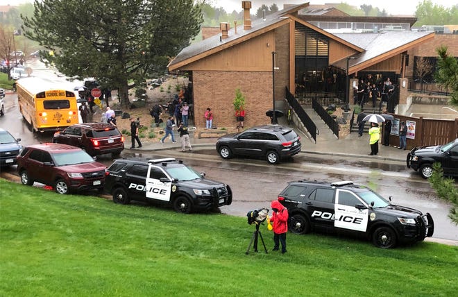 Police and others are seen outside a recreation center where students are reunited with their parents, in the Denver suburb of Highlands Ranch, Colo., after a shooting at STEM School Highlands Ranch Tuesday, May 7, 2019. Authorities said several people were injured and a few suspects were in custody. (AP Photo/David Zalubowski)
