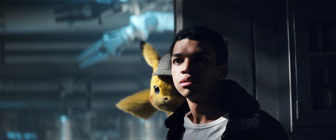Pikachu (voice of Ryan Reynolds) and Tim (Justice Smith) find themselves wrapped up in a mystery. [Warner Bros.]