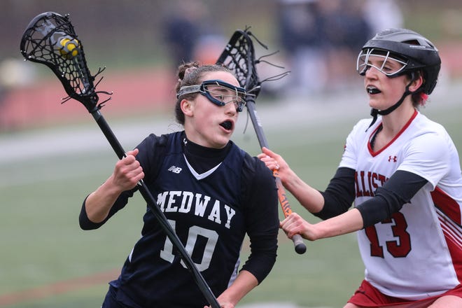 Medway's Ava Vasile drives to the net during game against Holliston earlier this season. Vasile recorded 200th career goal in the Mustangs 12-11 win over Ursuline on Tuesday. [Daily News and Wicked Local File Photo/Dan Holmes]