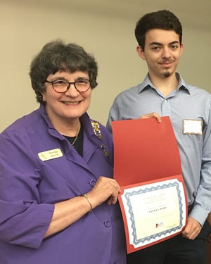 Daughters of the American Revolution Regent Martha Hazen presents a certificate to scholarship recipient Nathan Ward at the organization's April meeting. Ward is a second year junior at Flagler College majoring in economics. [CONTRIBUTED]