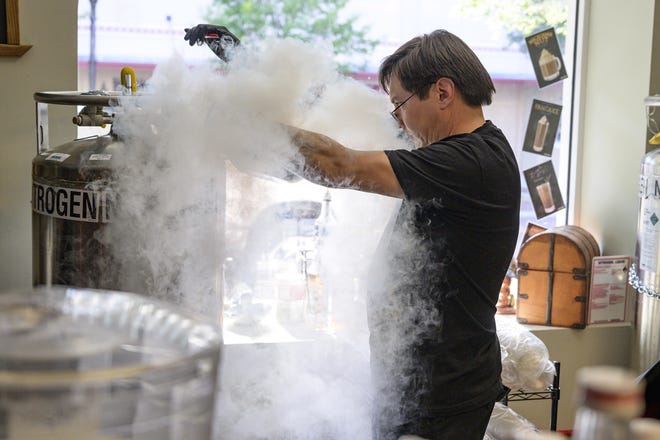 Owner Jairo Patino adds liquid nitrogen to an ice cream base to create nitro ice cream. [Cindy Sharp/Correspondent]