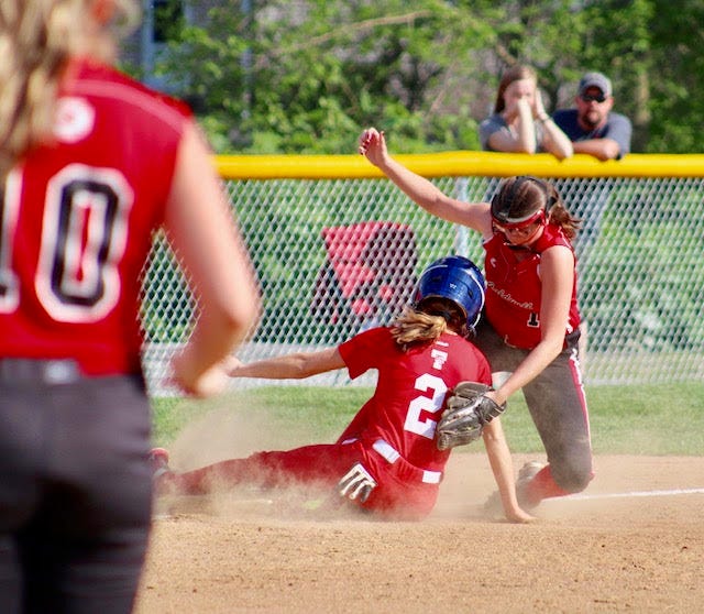 Caldwell High's Maria Blaker attempts to tag out Toronto's Shanna Reed during Wednesday's Division IV Sectional Tournament final. The Lady Knights beat the Lady Redskins, 11-1.