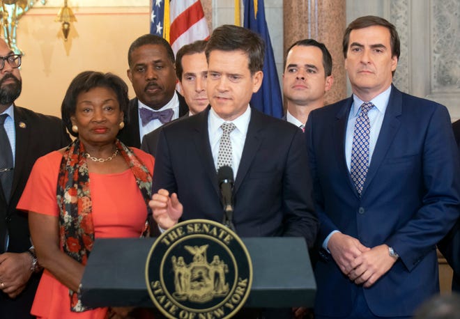 New York State Senator Brad Hoylman, D-Manhattan, center, speaks during a news conference, Wednesday, May 8, 2019, at the Capitol in Albany, N.Y., about a senate bill to authorize the release of individual New York state tax returns to Congress. Listening at left is Senate Majority Leader Andrea Stewart-Cousins, D-Yonkers, state Sen. Michael Gianaris, D-Queens, right. The bill now goes to the Democrat-led state Assembly after the Democrat-controlled Senate easily passed it. (AP Photo/Tim Roske)