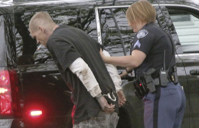 White Pigeon Police Sgt. Ashley Zimmer takes Matthew Gear into custody Tuesday following a police pursuit.