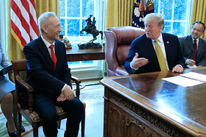 FILE - In this April 4, 2019, file photo, President Donald Trump meets China's Vice Premier Liu He in the Oval Office of the White House in Washington. (AP Photo/Manuel Balce Ceneta, File)