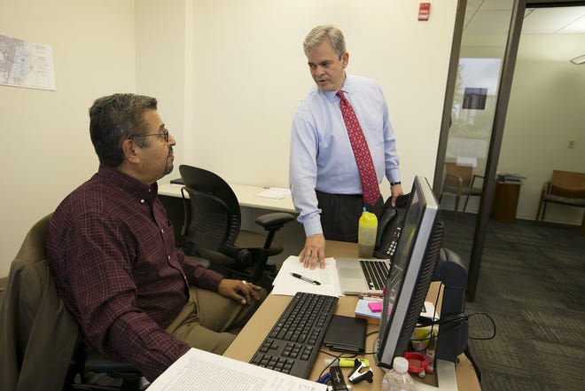Frank Rodriguez, talking in 2015 with his one-time boss, Austin Mayor Steve Adler, is at the center of a 723-page ethics complaint that has been stalled for nine months. The city's Ethics Review Commission delayed action on it again Wednesday. [DEBORAH CANNON / AMERICAN-STATESMAN]