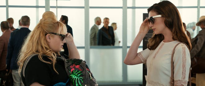 Penny (Rebel Wilson) and Josephine (Anne Hathaway) give each other the once-over. [MGM]