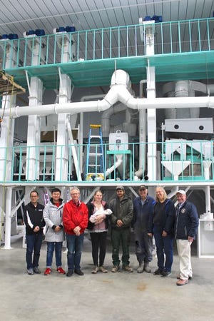 Yi Qiu, Wang Zhen (Inner Mongolia Agricultural University), Dr. Alan Taylor (Cornell University/Geneva AgriTech), Hanna Martens, Emily Martens, Peter Martens, Klaas Martens, Mary-Howell Martens, and NY Commissioner of Agriculture Richard Ball in the Martens new seed cleaning facility.