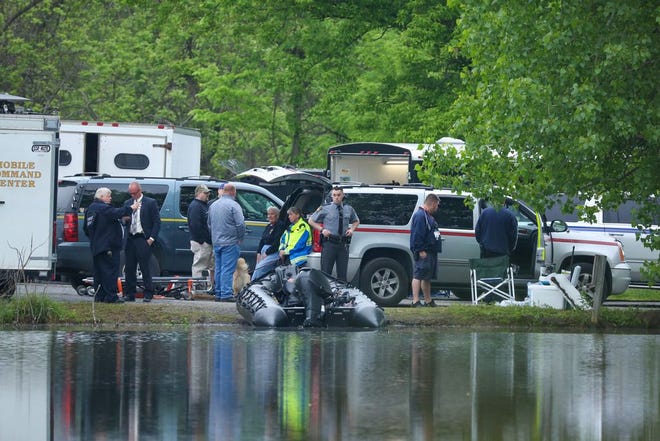 Emergency responders who helped with the search for a missing 51-year-old man in the area of Knob Road near Mercersburg are pictured by a pond where the man was found Thursday morning. JOHN IRWIN/ECHO PILOT