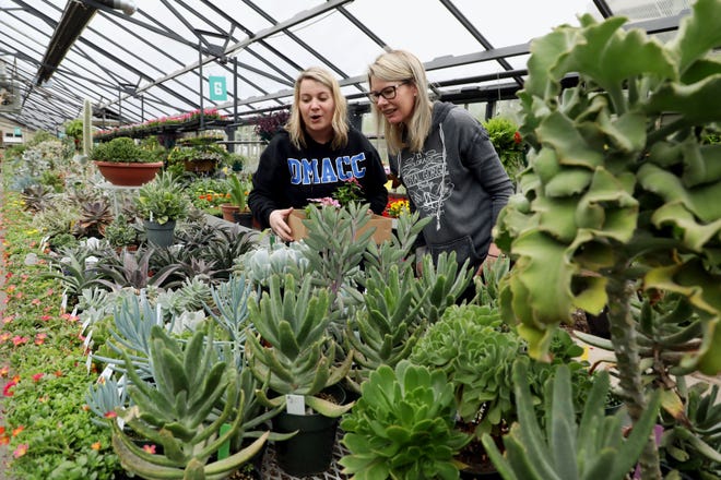 Kailey Booten, left, and her mother, Tracy Horner, both of Fort Madison, continue a Mother's Day tradition of visiting a greenhouse to pick out plants Wednesday at Zaiser's Landscaping Florist & Greenhouse in Burlington. The visit was the duo's first time to the Burlington greenhouse. Tracy Horner will spend Mother's Day at home with her daughters working in her garden. [John Lovretta/thehawkeye.com]