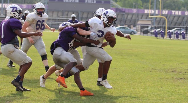 Receiver Dajan Watkins is brought down after making a catch and run during Dutchtown's spring practice. Photo by Kyle Riviere.