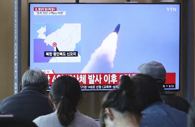 People watch a TV showing file footage of North Korea's missile launch during a news program at the Seoul Railway Station in Seoul, South Korea, on Thursday. North Korea on Thursday fired at least one unidentified projectile from the country's western area, South Korea's military said, the second such launch in the last five days and a possible warning that nuclear disarmament talks could be in danger. The signs read: North Korea fired unidentified projectiles". [AP Photo/Ahn Young-joon]